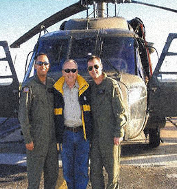 Major General Lou Hennies, center in front of an MH-60 Nighthawk